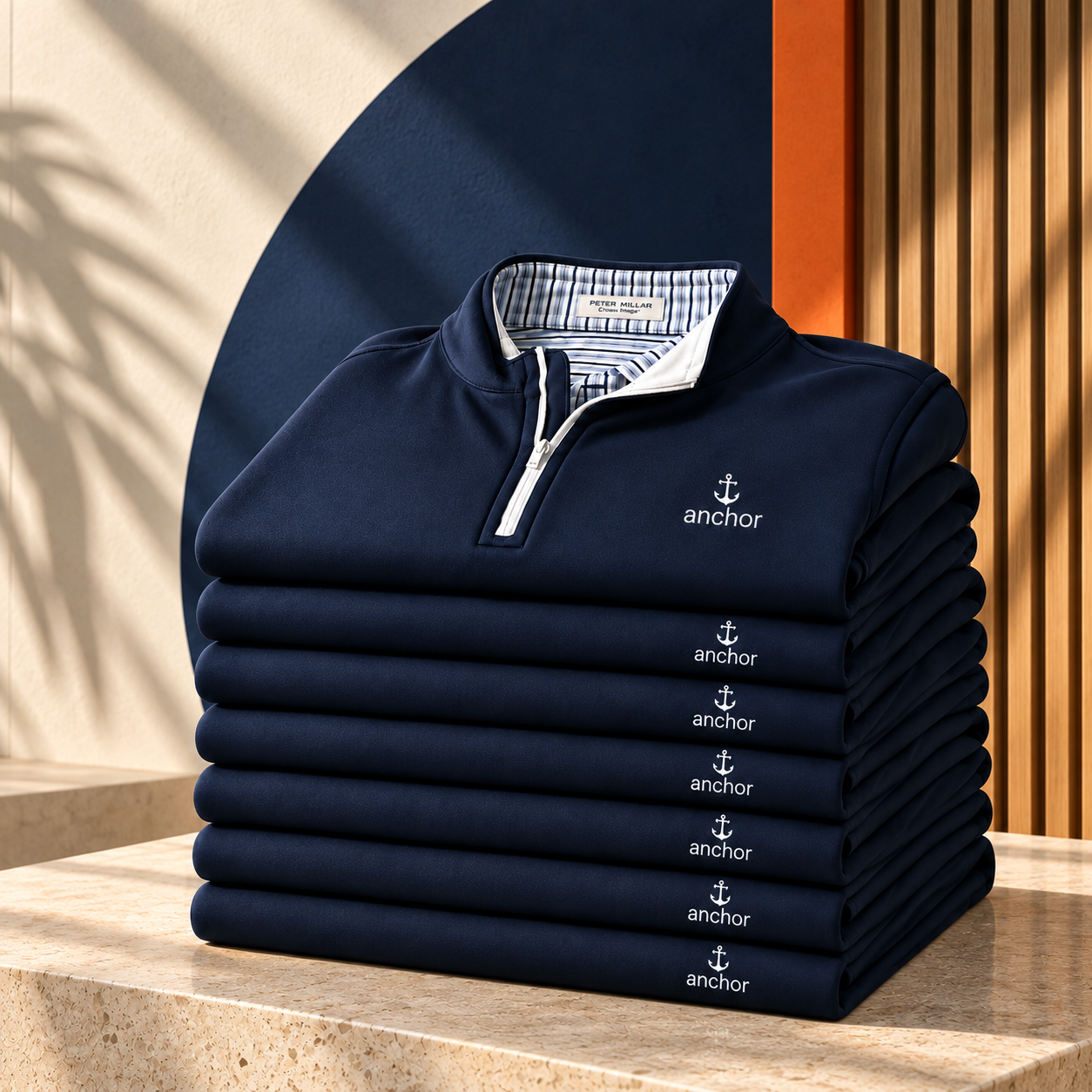 A stack of matching navy quarter-zips with white Anchor embroidery